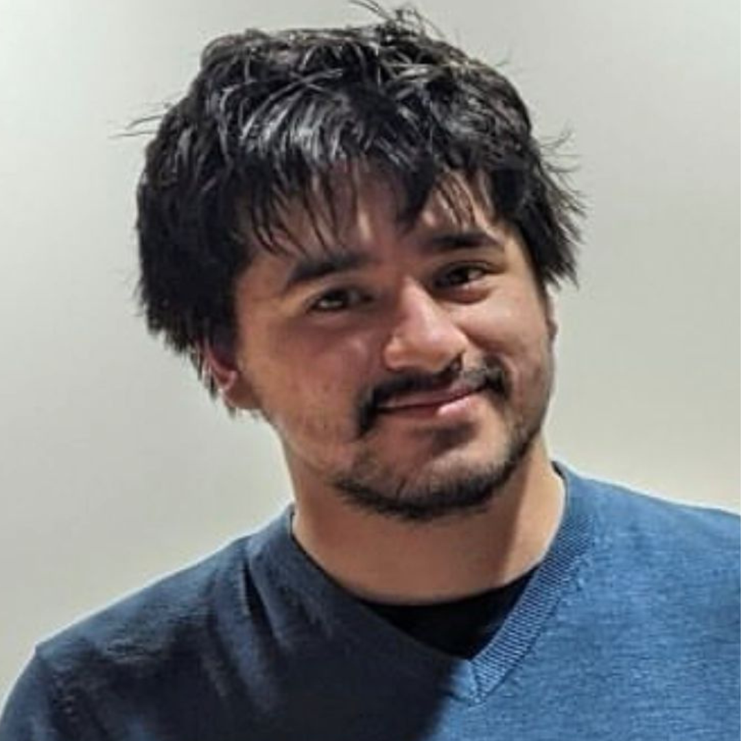 Smiling man wearing blue jumper