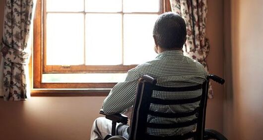 Elderly man looking out window Elderly man looking out window
