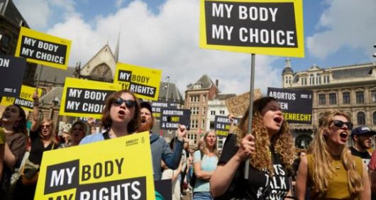 Amnesty International activists holding My Body, My Rights/Choice placards stage abortion rights protest in the Netherlands