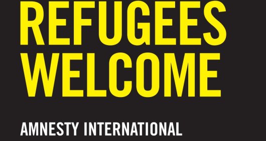 Sign in Amnesty branded Yellow and Black colour saying Refugees Welcome