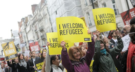 Sign reads "I wecome" at a Refugees Welcome March,  London