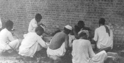 Pakistani prisoners breaking rocks in the prison yard