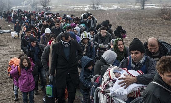  Migrants and refugees wait for security check after crossing the Macedonian border into Serbia