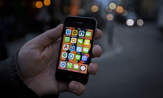 A close-up image of a hand holding a smartphone