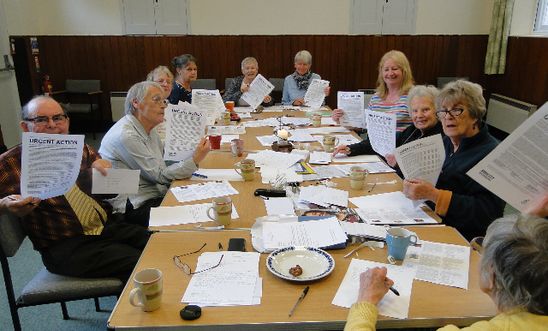 Members holding up urgent action case sheets