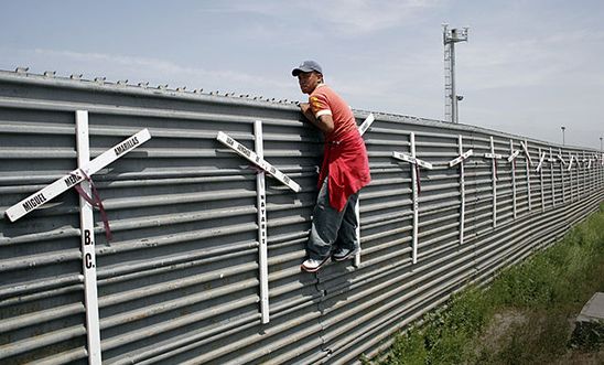 Migrant from Mexico into the US at the Tijuana-San Diego border. The crosses represent the deaths of failed attempts.