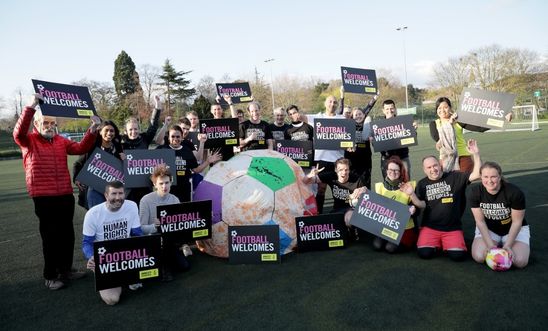 Picture shows activists with Football Welcomes banners and placards