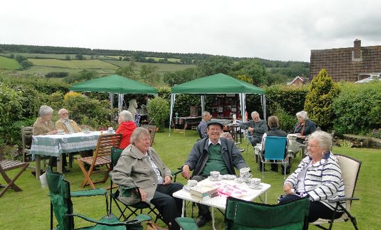 People drinking tea in a garden