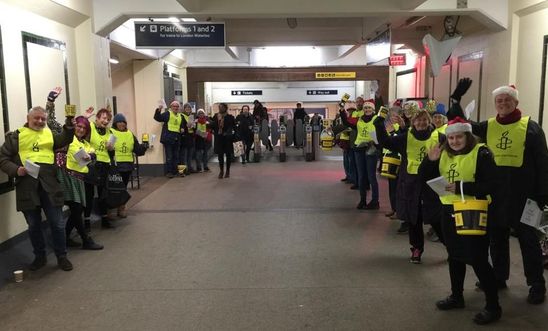 Amnesty Kingston carol singers at Surbiton Station