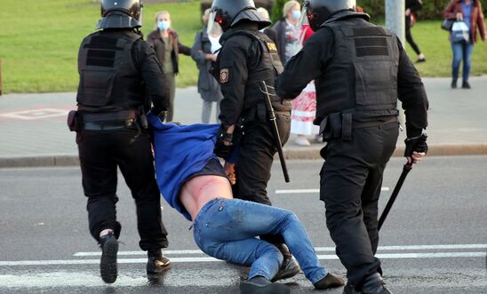  Riot police officers detain a man during an opposition rally to protest against the presidential inauguration in Minsk on September 23, 2020