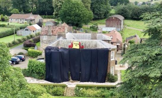 Image of the Prime Minister's constituency's home covered in black fabric after Greenpeace staged a peaceful protest