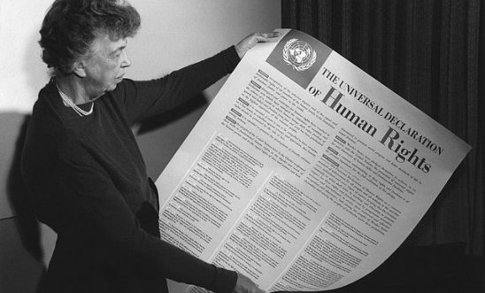 Eleanor Roosevelt holding poster of the Universal Declaration of Human Rights (in English), Lake Success, New York. November 1949.