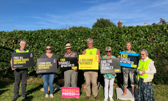 Members hold Amnesty signs