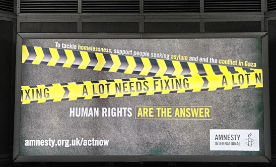 Photo reads: A Lot Needs Fixing - Human Rights are the Answer