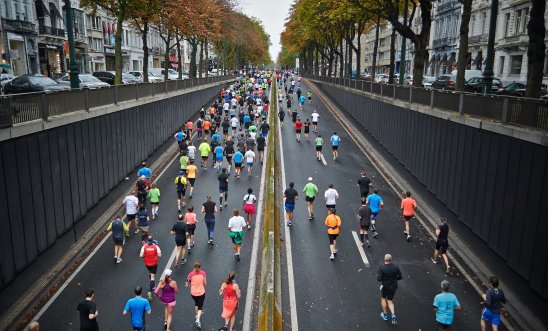 Image shows runners running a paved road