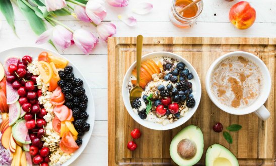 Image shows fruits and coffee laid out on a table