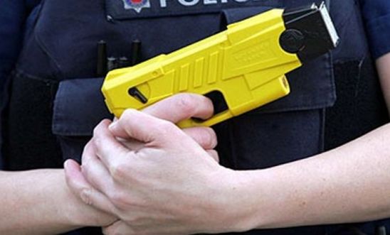 police officer holding Taser 