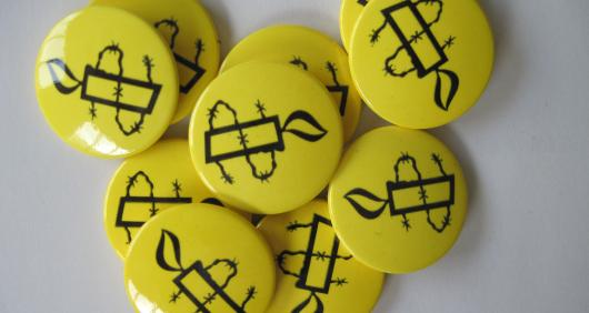 Amnesty Candle Pin Badges Yellow (Bag of 10) | Amnesty International UK